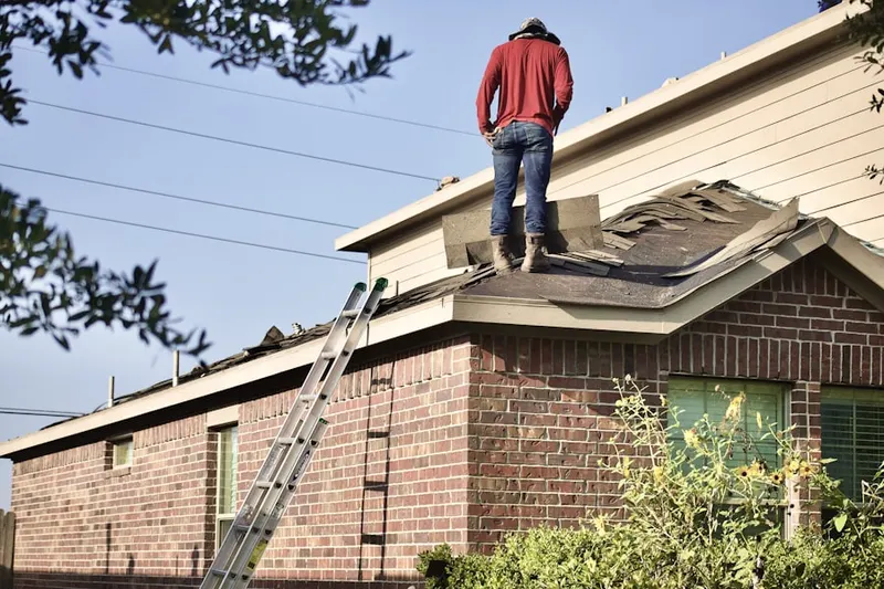 Professional roofer working on a residential roof in Marathon